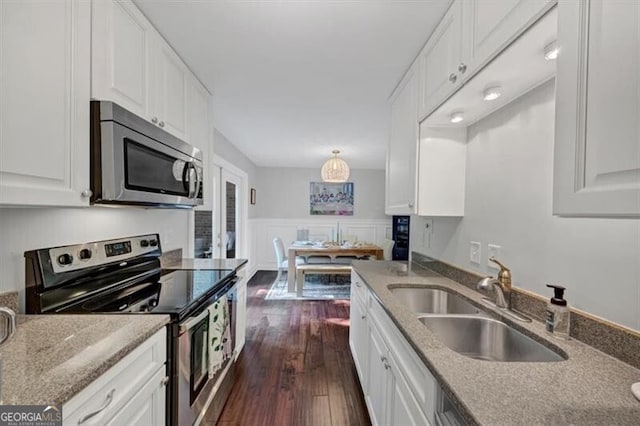 2 Arpege Way NW, Atlanta, GA 30327 - kitchen with appliances with stainless steel finishes, a sink, white cabinetry, dark wood-style floors, and a wainscoted wall