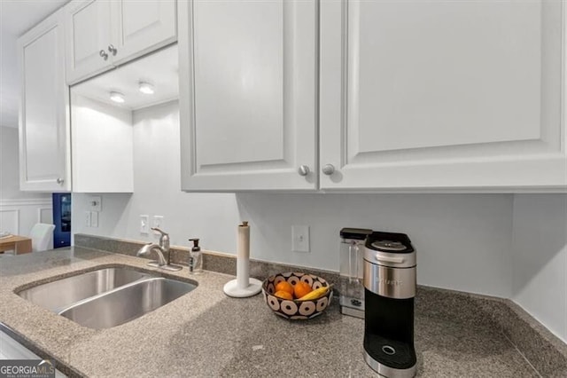2 Arpege Way NW, Atlanta, GA 30327 - kitchen featuring white cabinetry, a sink, and light stone countertops