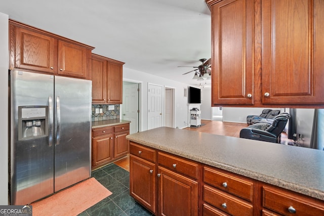 2958 Paul Harris Rd, Dallas, GA 30157 - kitchen with stainless steel fridge with ice dispenser, ceiling fan, backsplash, brown cabinets, and dark tile patterned floors