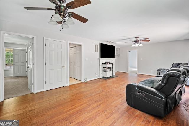 2958 Paul Harris Rd, Dallas, GA 30157 - living room featuring ceiling fan, light wood-type flooring, and a fireplace