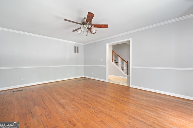2958 Paul Harris Rd, Dallas, GA 30157 - empty room featuring ceiling fan, wood finished floors, crown molding, and stairway