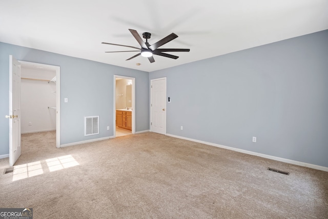 2958 Paul Harris Rd, Dallas, GA 30157 - unfurnished bedroom with carpet flooring, a walk in closet, ensuite bathroom, a ceiling fan, and a closet