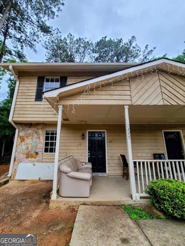 1225 Creek Forest Ct NW, Conyers, GA 30012 - view of front of home featuring covered porch and stone siding