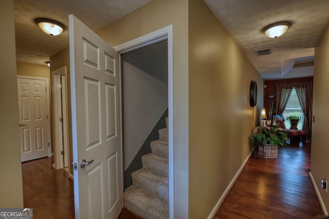 55 Ashton Pl, Covington, GA 30016 - hallway with dark wood-style floors, baseboards, a textured ceiling, and stairway