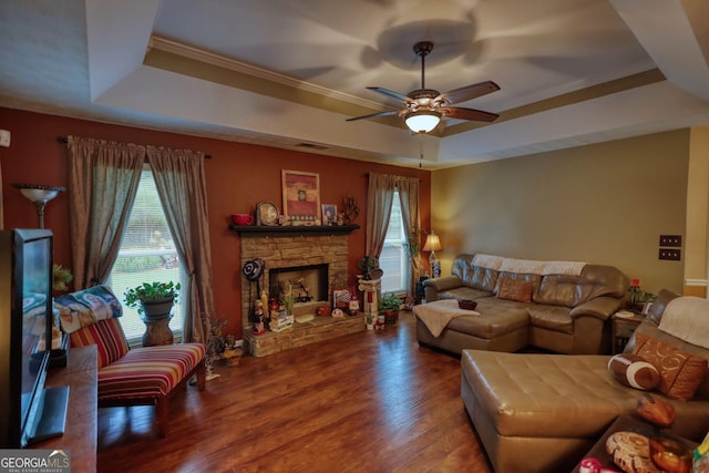 55 Ashton Pl, Covington, GA 30016 - living area featuring a tray ceiling, ceiling fan, a fireplace, wood finished floors, and crown molding