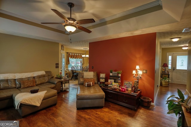 55 Ashton Pl, Covington, GA 30016 - living area featuring a tray ceiling, wood finished floors, healthy amount of natural light, ceiling fan, and crown molding