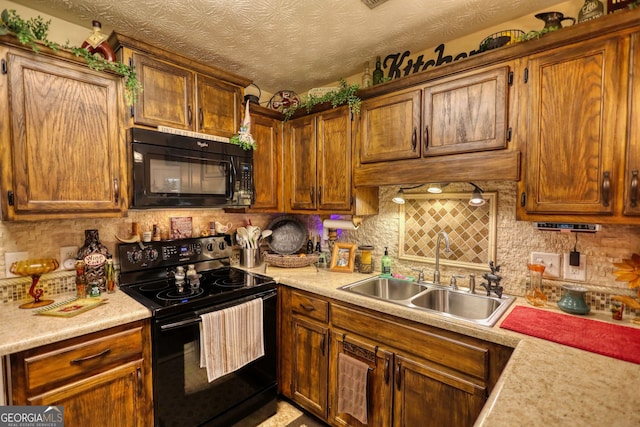 55 Ashton Pl, Covington, GA 30016 - kitchen featuring black appliances, a sink, decorative backsplash, and light countertops
