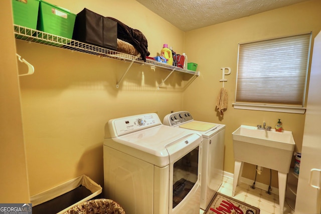 55 Ashton Pl, Covington, GA 30016 - laundry room with washing machine and clothes dryer and a textured ceiling