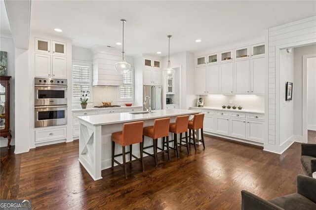 5971 Brundage Ln, Norcross, GA 30071 - kitchen with stainless steel appliances, decorative backsplash, light countertops, an island with sink, and recessed lighting