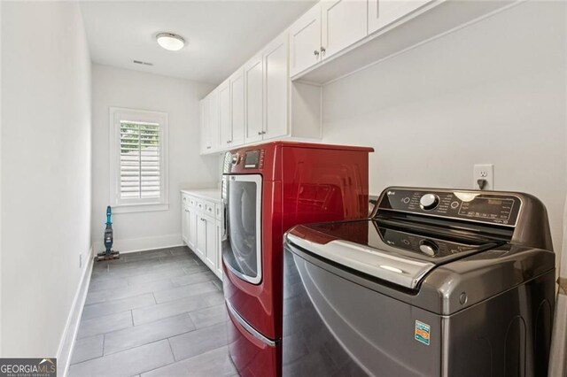 5971 Brundage Ln, Norcross, GA 30071 - laundry area with washing machine and dryer, cabinet space, and tile patterned flooring