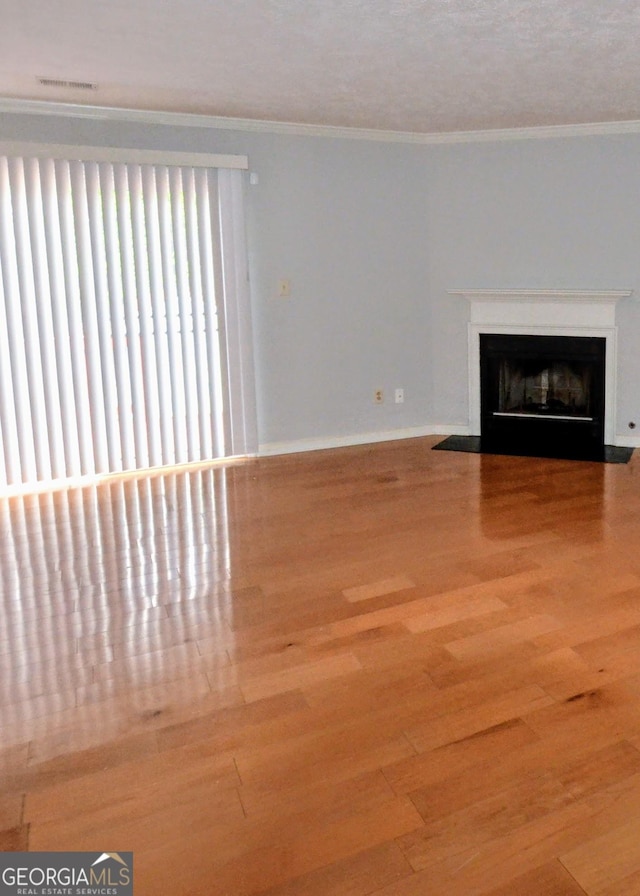 775 Heritage Valley Rd, Norcross, GA 30093 - unfurnished living room with a fireplace with flush hearth, wood finished floors, ornamental molding, and baseboards