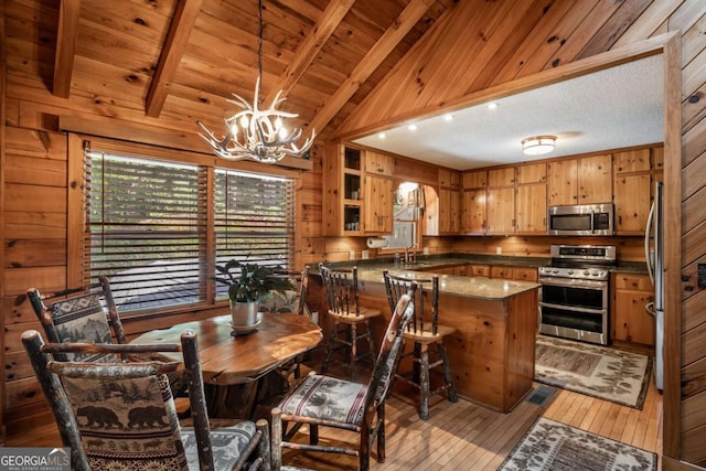 371 Little Rock Creek Ct, Cherry Log, GA 30522 - dining area featuring wood walls, light wood-style flooring, a chandelier, and wooden ceiling