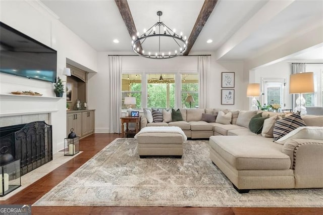 2680 Augeron Ct, Alpharetta, GA 30004 - living area with dark wood-style flooring, a chandelier, plenty of natural light, beamed ceiling, and a tile fireplace
