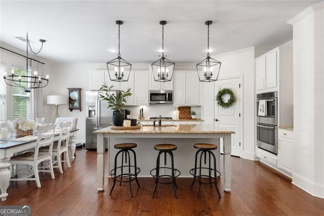 2680 Augeron Ct, Alpharetta, GA 30004 - kitchen featuring a chandelier, appliances with stainless steel finishes, dark wood-style flooring, and a kitchen island with sink