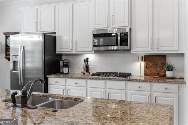 2680 Augeron Ct, Alpharetta, GA 30004 - kitchen featuring appliances with stainless steel finishes, white cabinets, backsplash, and light stone countertops