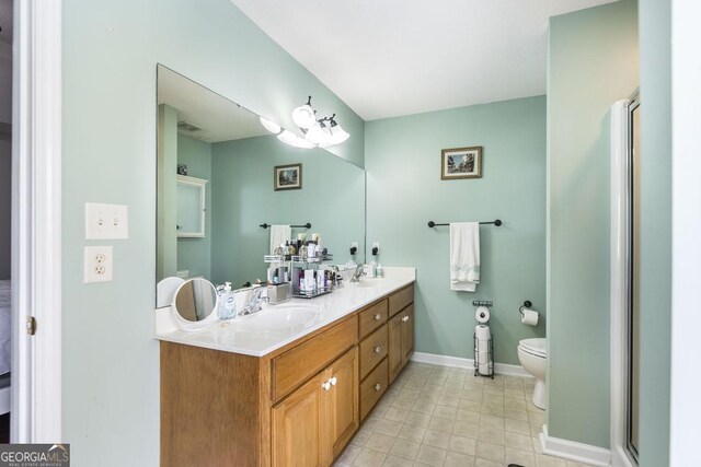 76 Duke Ln, Kathleen, GA 31047 - full bath featuring double vanity, an enclosed shower, and tile patterned floors