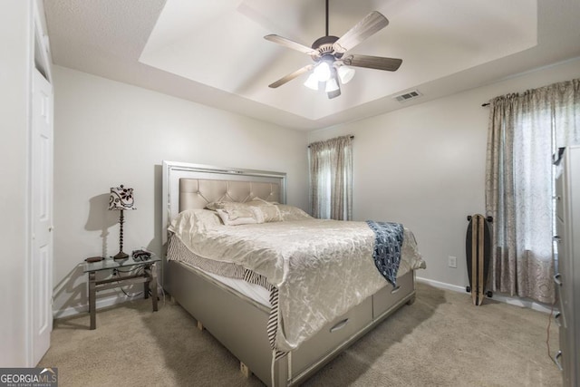 76 Duke Ln, Kathleen, GA 31047 - bedroom featuring light colored carpet, a tray ceiling, and a ceiling fan