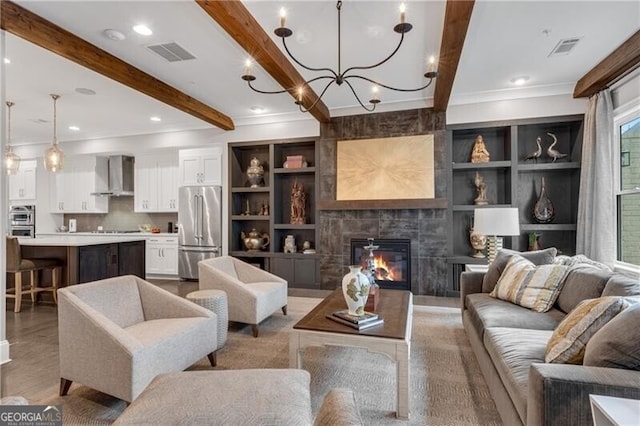 6445 Lucent Ln, Atlanta, GA 30328 - living room featuring beam ceiling, ornamental molding, a tile fireplace, a chandelier, and built in features