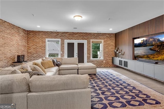 6445 Lucent Ln, Atlanta, GA 30328 - living room with brick wall, wood finished floors, and recessed lighting