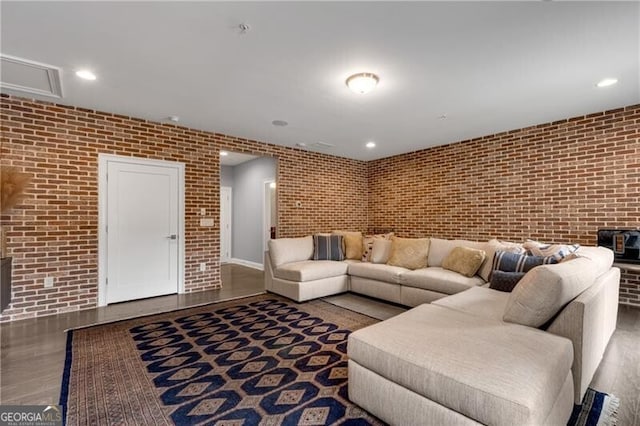 6445 Lucent Ln, Atlanta, GA 30328 - living area with brick wall, wood finished floors, and recessed lighting