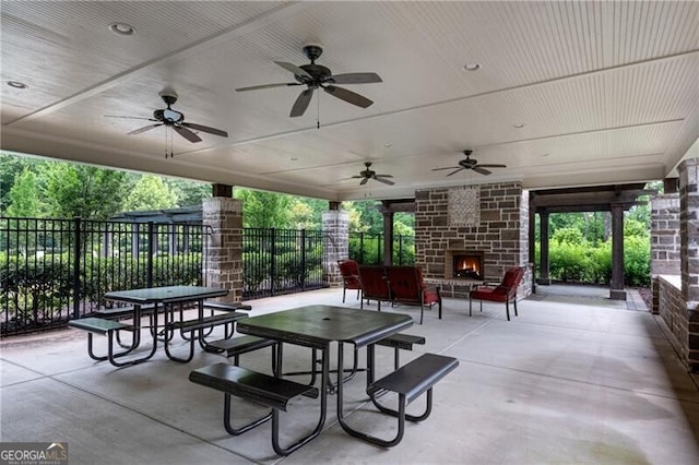 6445 Lucent Ln, Atlanta, GA 30328 - view of patio / terrace featuring an outdoor stone fireplace and ceiling fan