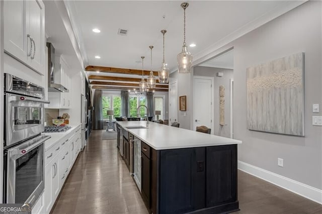 6445 Lucent Ln, Atlanta, GA 30328 - kitchen with a sink, stainless steel appliances, dark wood-type flooring, light countertops, and a spacious island