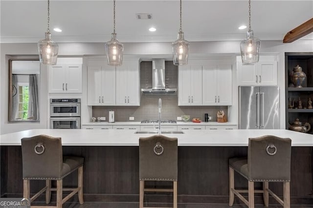 6445 Lucent Ln, Atlanta, GA 30328 - kitchen featuring stainless steel appliances, wall chimney exhaust hood, a spacious island, light countertops, and backsplash