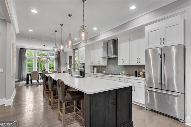 6445 Lucent Ln, Atlanta, GA 30328 - kitchen featuring stainless steel appliances, wall chimney exhaust hood, light countertops, white cabinetry, and recessed lighting