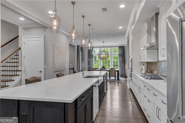 6445 Lucent Ln, Atlanta, GA 30328 - kitchen with wall chimney exhaust hood, stainless steel appliances, a large island with sink, white cabinets, and recessed lighting