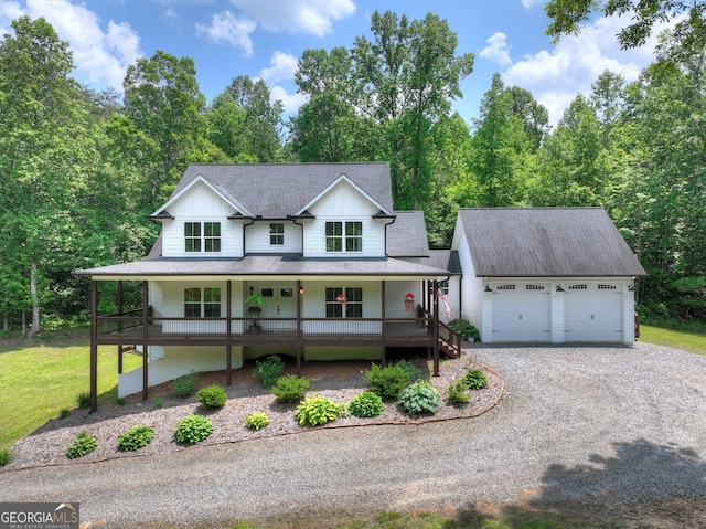 57 Clear Creek Valley Dr Unit 8A, Ellijay, GA 30536 - view of front of house with a porch, driveway, a garage, a shingled roof, and an outbuilding