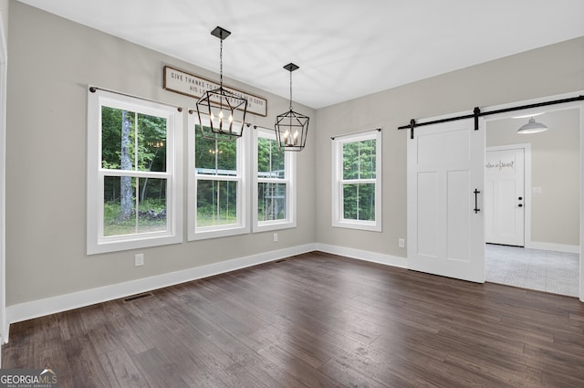 57 Clear Creek Valley Dr Unit 8A, Ellijay, GA 30536 - unfurnished dining area with dark wood finished floors, baseboards, a barn door, and a chandelier