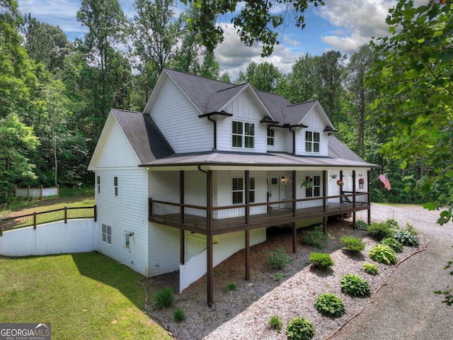 57 Clear Creek Valley Dr Unit 8A, Ellijay, GA 30536 - modern farmhouse featuring roof with shingles, covered porch, board and batten siding, and view of scattered trees