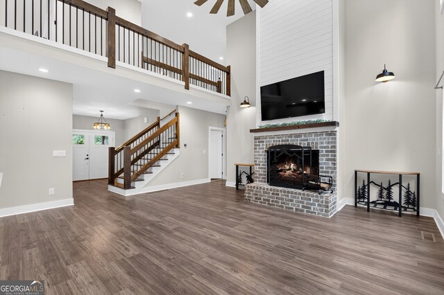 57 Clear Creek Valley Dr Unit 8A, Ellijay, GA 30536 - unfurnished living room with stairway, a high ceiling, wood finished floors, ceiling fan, and a fireplace