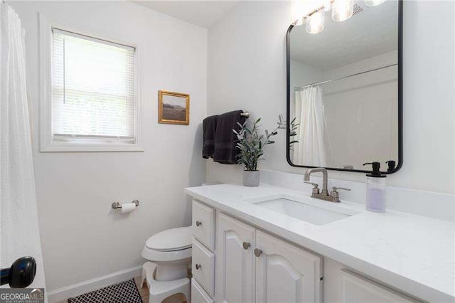3185 Perch Dr SW, Marietta, GA 30008 - bathroom featuring vanity, toilet, baseboards, and a shower with curtain