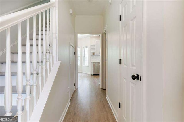 3185 Perch Dr SW, Marietta, GA 30008 - hall featuring light wood-type flooring, stairway, crown molding, and baseboards