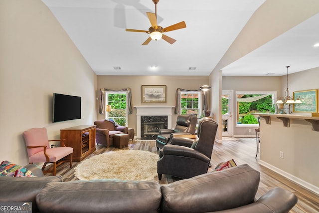 3633 Gilpin Ct, Lawren, GA 30044 - living room with light wood-style floors, ceiling fan, baseboards, a high end fireplace, and lofted ceiling