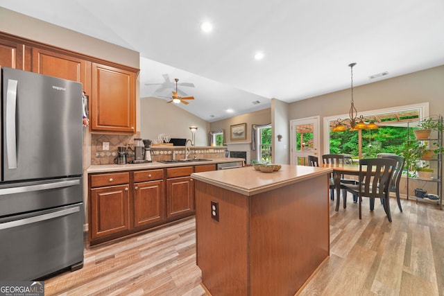 3633 Gilpin Ct, Lawren, GA 30044 - kitchen with appliances with stainless steel finishes, vaulted ceiling, light wood-type flooring, a sink, and light countertops