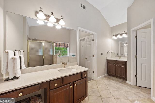 3633 Gilpin Ct, Lawren, GA 30044 - bathroom featuring vaulted ceiling, a stall shower, two vanities, tile patterned flooring, and baseboards