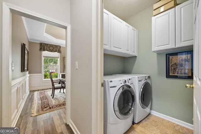 3633 Gilpin Ct, Lawren, GA 30044 - laundry room with cabinet space, washing machine and clothes dryer, and light wood-style flooring