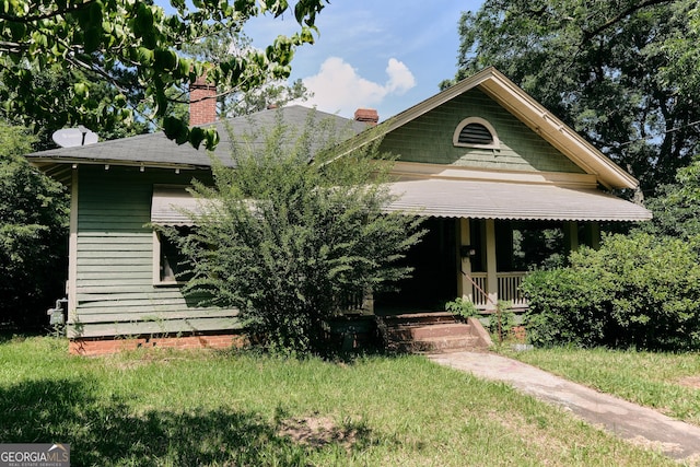 8 D Ave, Thomaston, GA 30286 - view of front of house with a chimney, a shingled roof, and covered porch
