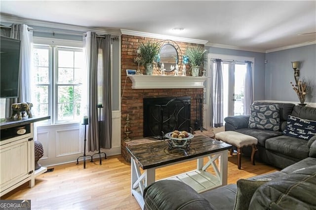 2050 Lyda Ln, Loganville, GA 30052 - living area featuring light wood-style flooring, a brick fireplace, and crown molding
