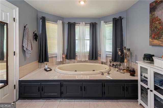 2050 Lyda Ln, Loganville, GA 30052 - bathroom featuring a jetted tub and tile patterned flooring