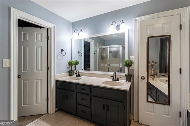2050 Lyda Ln, Loganville, GA 30052 - full bath with double vanity, a shower stall, and tile patterned flooring
