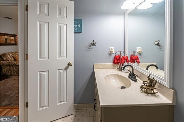 2050 Lyda Ln, Loganville, GA 30052 - ensuite bathroom with vanity, tile patterned flooring, and baseboards
