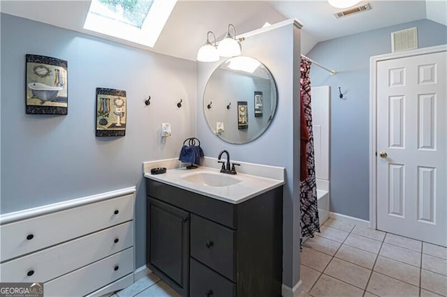 2050 Lyda Ln, Loganville, GA 30052 - bathroom with a skylight, vanity, vaulted ceiling, tile patterned floors, and shower / bath combo with shower curtain