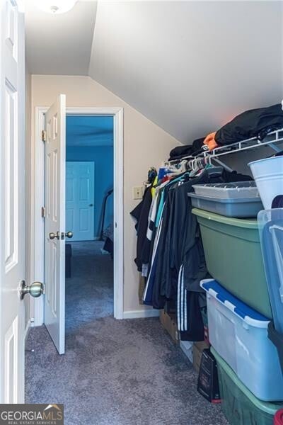 2050 Lyda Ln, Loganville, GA 30052 - walk in closet featuring carpet floors and vaulted ceiling