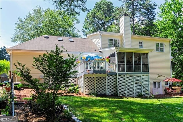 2050 Lyda Ln, Loganville, GA 30052 - rear view of house with a sunroom, a chimney, a yard, and a wooden deck