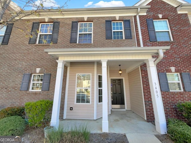 2555 Flat Shoals Rd Unit 3405, Atlanta, GA 30349 - view of exterior entry with brick siding and a porch