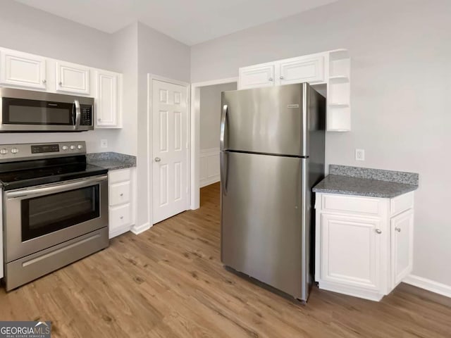 2555 Flat Shoals Rd Unit 3405, Atlanta, GA 30349 - kitchen featuring stainless steel appliances, white cabinetry, and light wood-type flooring