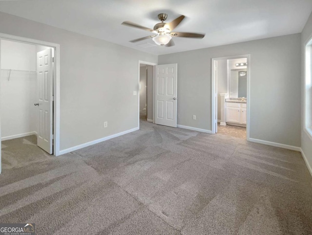 2555 Flat Shoals Rd Unit 3405, Atlanta, GA 30349 - unfurnished bedroom featuring light carpet, a spacious closet, ensuite bathroom, a ceiling fan, and a closet